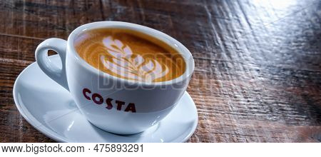 Cup Of Costa Coffee On A Wooden Table