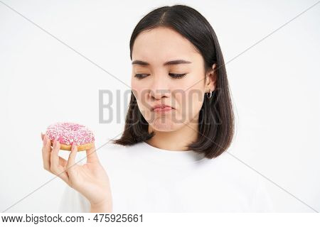 Close Up Of Sad Cute Girl, Shows Tasty Glazed Doughnut, Being On Diet, Cant Try Delicious Donnut, Ju