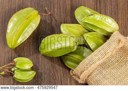 Star Fruit Or Carambola Green - Averrhoa Carambola; Photo On Wooden Background