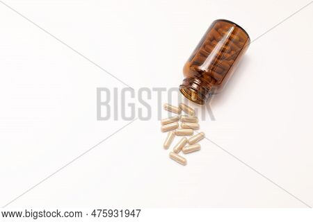 Flatly Group Of Scattered Slippery Elm Capsules, Dark Glass Bottle On White Background. Traditional,