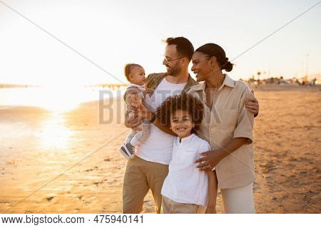 Beachside Bonding. Happy Multiracial Family Walking And Enjoying Time Together On Beach During Holid
