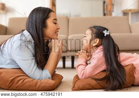 Happy Japanese Mom And Daughter Talking Enjoying Moment At Home