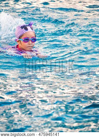 Asian Child Or Kid Girl Wearing Swimming Suit To Learning On Swimming Pool , Learn And Training Swim