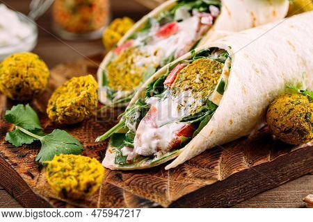 Portion Of Vegetarian Falafel Wrap Roll On Board