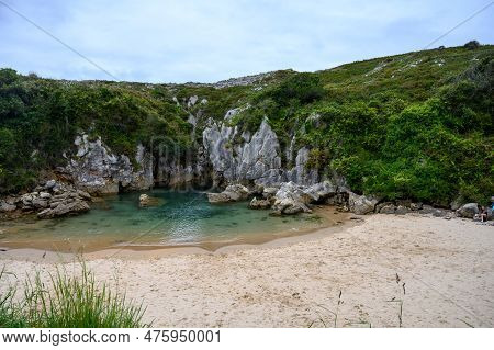 Playa De Gulpiyuri, Flooded Sinkhole With Inland Beach Near Llanes, In Asturias Northern Spain, Arou