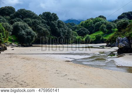 View On Playa De Poo During Low Tide Near Llanes, Green Coast Of Asturias, North Spain With Sandy Be