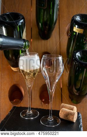 Glasses Of Sparkling White Wine Champagne Or Cava With Bubbles And Classic Wooden Champagne Pupitre