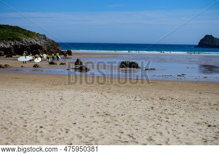 Young Surfers Train On Playa De Palombina Las Camaras In Celorio, Green Coast Of Asturias, North Spa