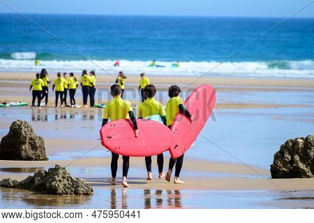 Young Surfers Train On Playa De Palombina Las Camaras In Celorio, Green Coast Of Asturias, North Spa