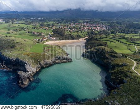 Aerial View On Playa De Poo During Low Tide Near Llanes, Green Coast Of Asturias, North Spain With S
