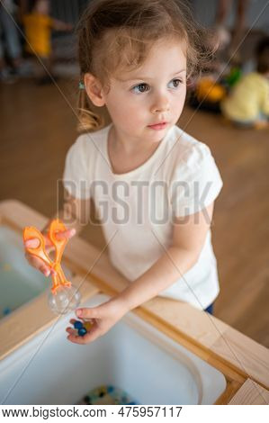 Little Girl Playing With Sensory Water Beads, Hydrogel Balls. Sensory Development And Experiences, T