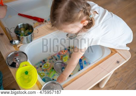 Little Girl Playing With Sensory Water Beads, Hydrogel Balls. Sensory Development And Experiences, T