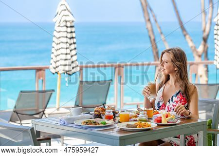 Buffet Breakfast In Hotel With Sea View. Smiling Traveler Woman Enjoy Food In Outdoor Cafe In Modern