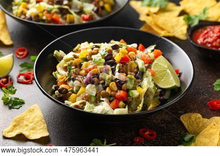 Mexican Style Salad Of Black Beans, Lentils, Corn, Tomato And Lettuce With A Salsa And Tortilla Chip