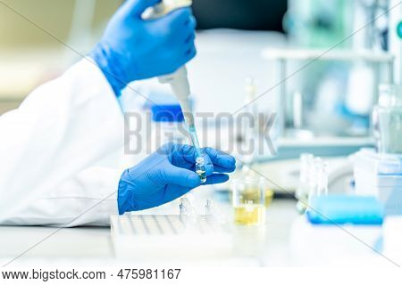 Pipetting Of Chemical Samples During Research In A Biochemical Scientific Laboratory