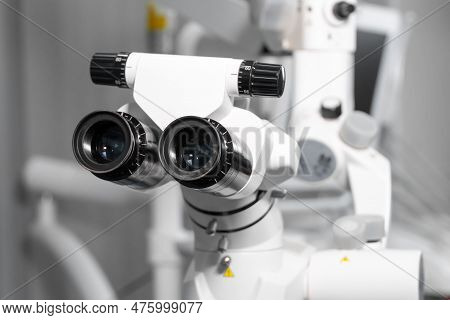 Surgical Microscope In Dental Clinic. Microsurgical With Doctors. Modern Dental Equipment And Instru