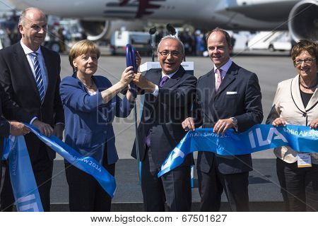 BERLIN, GERMANY - MAY 20, 2014: German Chancellor Angela Merkel, Turkish Minister of transport Lutfi Elvan and CEO Mr Christian (C.-R.) open up the International aviation and space exhibition ILA.