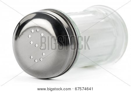 Glass saltcellar with salt on white background