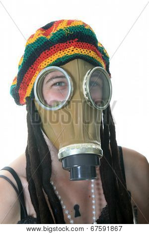 a girl in a gas mask wears her favorite Rastafarian style hat with built in Dred locks. isolated on white with room for your text.