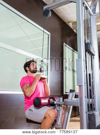 Cable Lat pulldown machine man workout at gym exercise