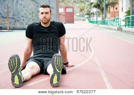 Man sitting on the running track