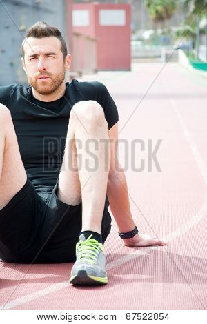 Man sitting on the running track
