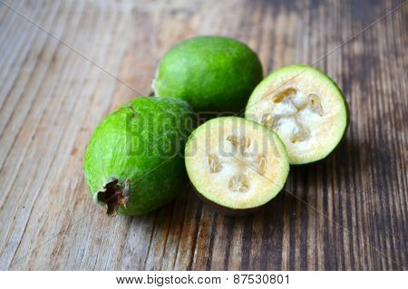 Green feijoa fruit on wooden table