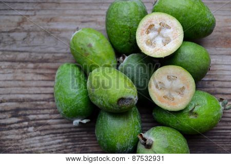 Green feijoa fruit on wooden table