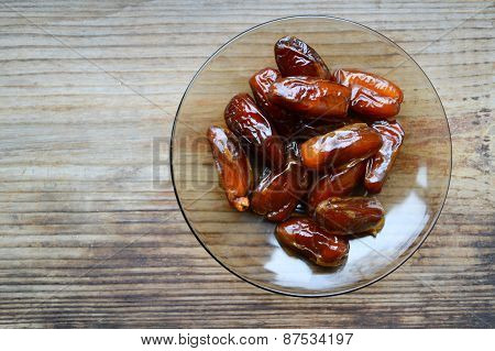 Brown dates fruit on wooden table