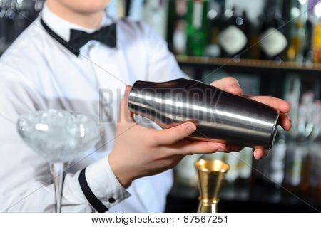 Barman makes tasty cocktails