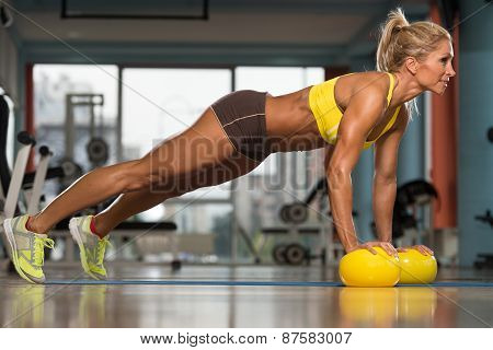 Woman Exercising Push Ups On Yellow Balls