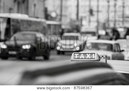 Taxi On City Streets In Monochrome Tones