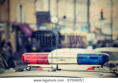 The Police Car Patrols City Streets