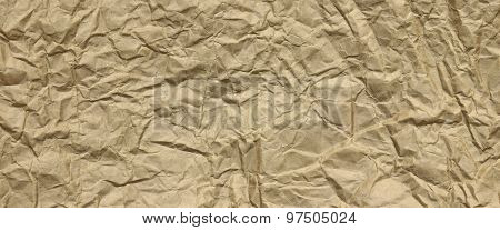 Close-up Of Rough Golden Brown Wrinkled Packaging Paper Texture Background
