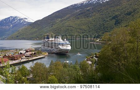 FLAAM, NORWAY - JUN 9 2015 : A cruise ship waits for returning passengers on the Aurlandsfjord.