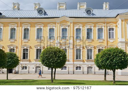 People walk in front of the Rundale palace facade in Pilsrundale, Latvia.