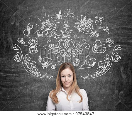 Young Woman Is Dreaming About Shopping. Shopping Icons Are Drawn On The Black Chalkboard.