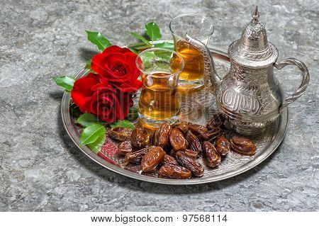 Tea, Dates Fruits And Red Rose Flowers. Islamic Holidays Decoration. Ramadan