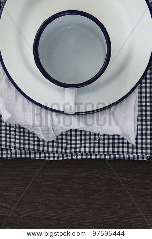 Vintage Enamelware Crockery On Retro Cloths On Rustic Wooden Background