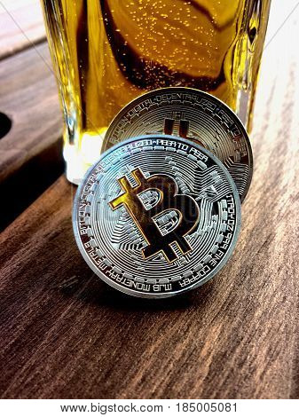 Digital currency physical silver bitcoin coin on wooden table