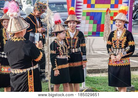 Penampang,Sabah-May 30,2016:Kadazandusun woman of Sabah in traditional costume taking photo by smartphone during Kaamatan festival in Kota Kinabalu,Sabah.