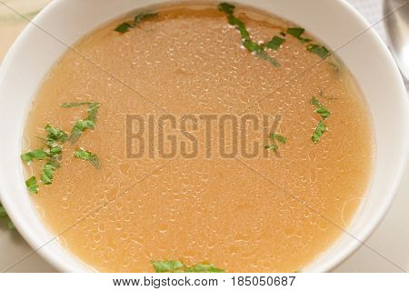 Bone Broth Made From Chicken, Served In A Bowl With Parsley