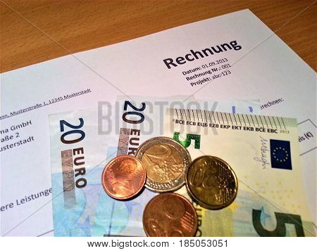 Some euro notes and coins with invoice