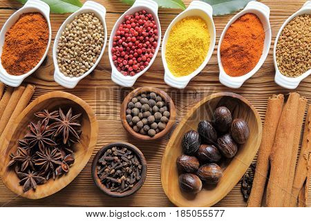 Spices in ceramic containers and wooden bowls. Food and cuisine ingradients.