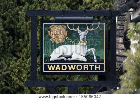 CASTLE COMBE UK - MAY 1 2017: The White Hart Wadworth Pub sign in Castle Combe Wiltshire UK