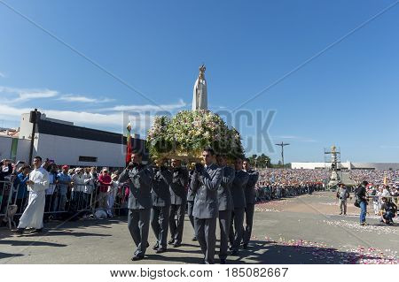Fatima Portugal - May 13 2014: Group of soldiers carrying the Statue of the Virgin Mary at the Sanctuary of Fatima during the celebrations of the apparition of the Virgin Mary in Fatima Portugal.