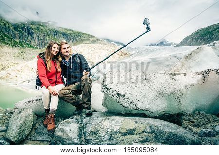 Young Couple Hiking in the Swiss Alps, Taking a Selfie.  
