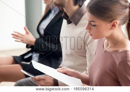 Group of young people waiting in the queue for their turn on casting audition or job interview, preparing and doing various activities, training and business seminar, students studying, close up