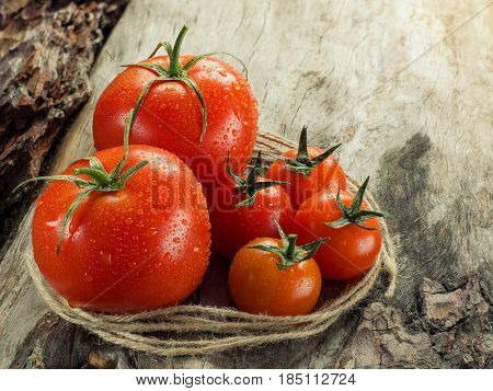 Fresh Juicy Tomatoes Close-up On An Old Wooden Table.