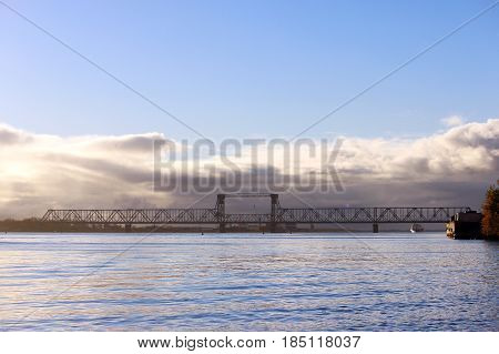 white cumulus clouds pass bridge over the Northern Dvina River.